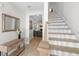 Bright and airy foyer showcasing wood floors, staircase, and a view into the open-concept living area at 8654 Windsor Hill Blvd, North Charleston, SC 29420