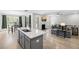Open-concept kitchen with a gray island, stainless steel appliances, and a dining area at 8654 Windsor Hill Blvd, North Charleston, SC 29420