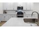 Modern kitchen featuring white cabinets, stainless steel appliances, and light countertops at 8654 Windsor Hill Blvd, North Charleston, SC 29420