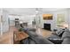 Open-concept living room and kitchen with wood floors, a fireplace, and modern gray couches at 8654 Windsor Hill Blvd, North Charleston, SC 29420