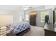 Bright main bedroom featuring a tray ceiling, ceiling fan, and natural light at 8654 Windsor Hill Blvd, North Charleston, SC 29420
