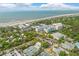 Aerial view of a coastal community that features tennis courts, hotels, and neighborhoods along the beach at 1 Bay Ct, Isle of Palms, SC 29451