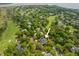 Serene aerial view of the property nestled amongst mature trees, close to golf course and waterways at 1 Bay Ct, Isle of Palms, SC 29451