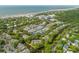 Breathtaking aerial view of a beach community offering tennis courts and lush landscape with a beautiful canal at 1 Bay Ct, Isle of Palms, SC 29451