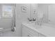The bathroom features a white vanity with gold fixtures, framed art, and a shower/tub with tile floors at 1 Bay Ct, Isle of Palms, SC 29451