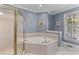 Bathroom with soaking tub and glass door shower at 1 Bay Ct, Isle of Palms, SC 29451