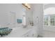 Bright bathroom featuring a white vanity with lots of counter space and a big mirror at 1 Bay Ct, Isle of Palms, SC 29451