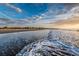 A scenic beach view features calming ocean waves meeting the sandy shore under a picturesque, cloudy sky at 1 Bay Ct, Isle of Palms, SC 29451