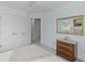 Bright bedroom featuring plush carpet, twin closets, and a wooden dresser with a gold trimmed mirror hanging above it at 1 Bay Ct, Isle of Palms, SC 29451