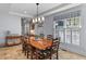 Formal dining room featuring a large wooden table, ladder-back chairs, and elegant lighting at 1 Bay Ct, Isle of Palms, SC 29451