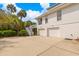 Rear exterior view of the home featuring a two car garage and a staircase leading up to an exterior balcony at 1 Bay Ct, Isle of Palms, SC 29451