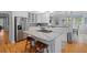 Modern kitchen with stainless steel appliances, an island with seating, and white cabinets at 1 Bay Ct, Isle of Palms, SC 29451