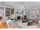 Bright living room with large windows, built-in shelving, and comfortable seating at 1 Bay Ct, Isle of Palms, SC 29451