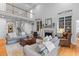Spacious living room with high ceilings, built-in bookshelves, and a cozy fireplace at 1 Bay Ct, Isle of Palms, SC 29451