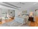Spacious bedroom featuring a sitting area, balcony access, and a decorative rug over hardwood floors at 1 Bay Ct, Isle of Palms, SC 29451
