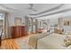 Bright bedroom featuring hardwood floors, tray ceiling, sitting area, and large windows at 1 Bay Ct, Isle of Palms, SC 29451