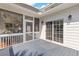 Outdoor porch with screened windows and sliding door to provide light and airflow at 1 Bay Ct, Isle of Palms, SC 29451