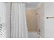 Bright and clean shower/tub combo featuring a white shower curtain and tile walls at 1 Bay Ct, Isle of Palms, SC 29451