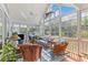 Charming sunroom filled with wicker furniture, nautical accents, and abundant natural light at 1 Bay Ct, Isle of Palms, SC 29451