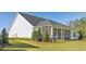 A sprawling backyard offers a screened-in porch, lush landscaping, and plenty of space for outdoor living at 1003 Sagegrass St, Summerville, SC 29485