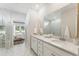 The bathroom features double vanity sinks, white cabinetry, marble floors, and a glass-enclosed shower at 1003 Sagegrass St, Summerville, SC 29485