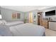 Comfortable bedroom with two beds, a TV, and ensuite bathroom at 1004 Ocean Blvd # 108, Isle of Palms, SC 29451