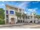 Exterior view of a condominium complex featuring balconies and palm trees, with access stairs at 1004 Ocean Blvd # 108, Isle of Palms, SC 29451