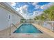 Relaxing pool and lounge area with a shallow end and palm trees at 1004 Ocean Blvd # 108, Isle of Palms, SC 29451