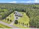 Expansive aerial view of a beautiful property featuring a well-manicured lawn, circular driveway, and a lovely home surrounded by lush trees at 1019 Spiers Cir, Bonneau, SC 29431