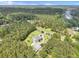 Overhead view of large home, with an expansive lawn, circular drive with fountain, pool and wooded acreage at 1019 Spiers Cir, Bonneau, SC 29431