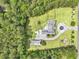 Birds eye view of residence and acreage surrounded by dense woods, showcasing layout, landscaping, and multiple buildings on the property at 1019 Spiers Cir, Bonneau, SC 29431