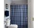 Cozy bathroom with a shower with blue plaid curtain and a toilet at 1019 Spiers Cir, Bonneau, SC 29431