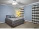 Charming bedroom featuring light blue walls, ceiling fan, and neutral carpeting at 1019 Spiers Cir, Bonneau, SC 29431