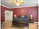 Spacious bedroom boasts dark red walls, hardwood floors, and traditional furnishings at 1019 Spiers Cir, Bonneau, SC 29431