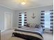 Comfortable bedroom with stylish nautical decor and bright natural light at 1019 Spiers Cir, Bonneau, SC 29431