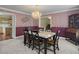 Elegant dining room with striped walls, chandelier lighting and adjacent kitchen access at 1019 Spiers Cir, Bonneau, SC 29431