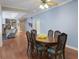 Charming dining room features wood floors and a view into the spacious living room at 1019 Spiers Cir, Bonneau, SC 29431
