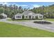Beautifully landscaped property with winding driveway and decorative wagon planter enhancing the curb appeal of the charming home at 1019 Spiers Cir, Bonneau, SC 29431