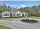 Charming home with manicured landscaping, circular driveway and decorative wagon planter under a sunny blue sky at 1019 Spiers Cir, Bonneau, SC 29431