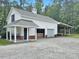 Exterior view of horse barn with attached covered equipment storage and exterior seating area at 1019 Spiers Cir, Bonneau, SC 29431