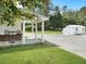 View of gravel parking area, utility shed, and outdoor seating area at 1019 Spiers Cir, Bonneau, SC 29431