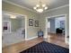Spacious foyer leading to multiple rooms with hardwood floors and elegant lighting fixtures at 1019 Spiers Cir, Bonneau, SC 29431