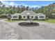 Charming single-story home with circular driveway, classic white facade, and lush, manicured landscaping at 1019 Spiers Cir, Bonneau, SC 29431