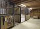 Horse stall with metal bars, wood panels, and concrete flooring at 1019 Spiers Cir, Bonneau, SC 29431