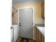 Functional laundry room includes a washer and dryer, cabinets, and an exterior door at 1019 Spiers Cir, Bonneau, SC 29431