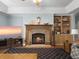 Inviting living room features a stone fireplace, TV, and built-in shelving at 1019 Spiers Cir, Bonneau, SC 29431