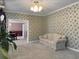 Cozy living room featuring floral wallpaper, a comfortable sofa, and an adjacent dining area at 1019 Spiers Cir, Bonneau, SC 29431