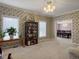 Elegant living room with ample natural light, a bookcase, and a view into the dining area at 1019 Spiers Cir, Bonneau, SC 29431