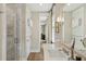 Bright bathroom featuring a marble vanity, glass enclosed shower and hardwood flooring at 104 May Ln, Mount Pleasant, SC 29464