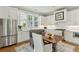 Bright eat-in kitchen features white cabinets, stainless steel appliances, and a modern design at 104 May Ln, Mount Pleasant, SC 29464